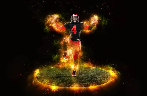 American football player, athlete sportsman in red helmet on dark background with fire. Sport and motivation wallpaper. Man celebrates victory — Stock Photo, Image