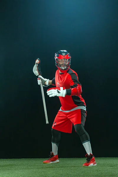 Lacrosse Player, atleta sportivo in casco rosso su sfondo scuro. Sport e motivazione carta da parati. — Foto Stock