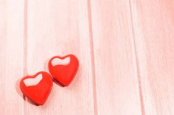 Hearts on coral wooden table — Stock Photo, Image