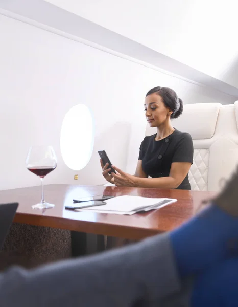 Businessman works on private plane — Stock Photo, Image