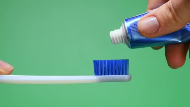 Squeezing tooth paste on toothbrush — Stock Video