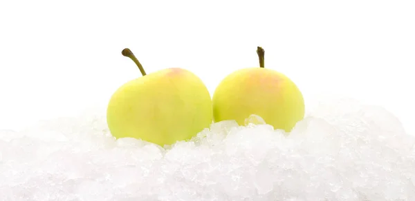 白で隔離された雪の中で黄色のリンゴ — ストック写真