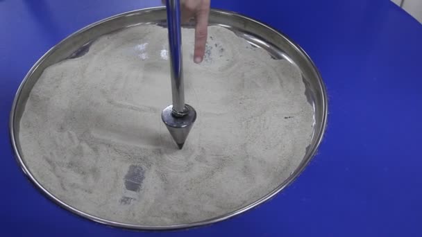 Pendulum Draws Ellipse Sand — Stock Video