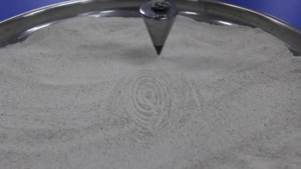 Pendulum Draws Ellipse Sand — Stock Video