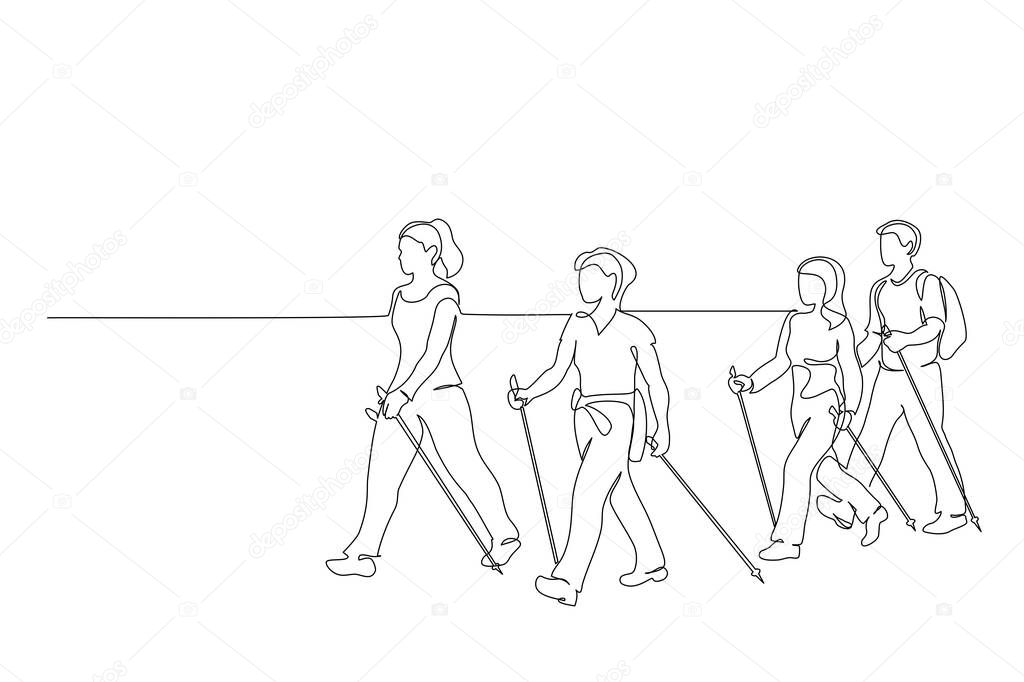 Group of people walks on foot with walking sticks. Nordic walking