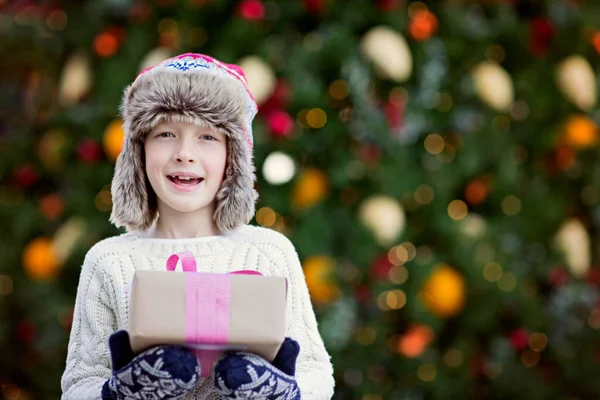 Cute Smiling Little Boy Holding Christmas Presents Decorated Tree Background — Stock Photo, Image