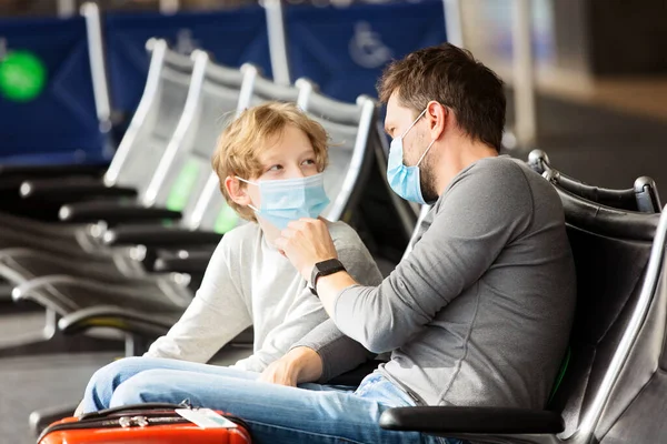 Father Adjusting His Son Face Mask Sitting Airport Terminal Travel — Stock Photo, Image