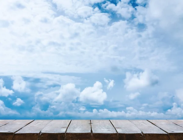 wooden table with sky background
