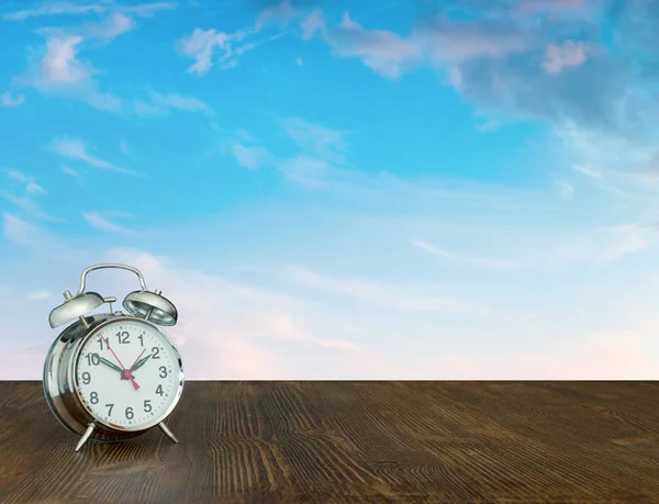 watch on wooden table, sky background