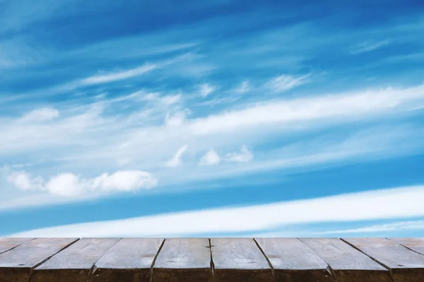 wooden table with sky background