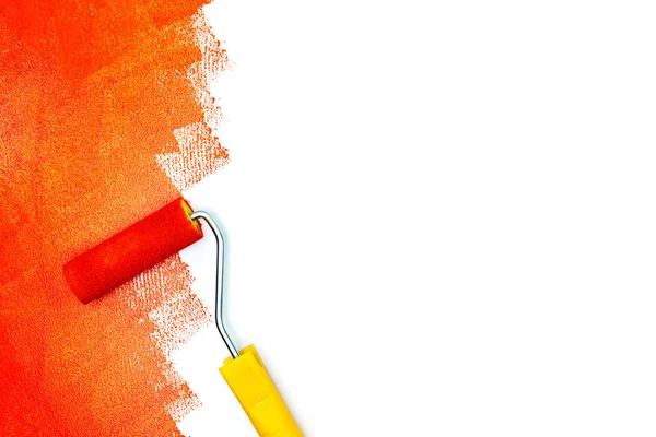 red paint strokes on white surface and paint roller flat view