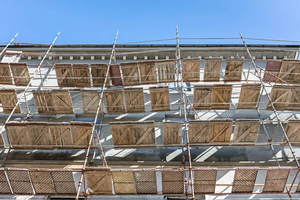 facade renovation of old house. scaffolding near the building wall.