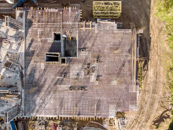 aerial top view of building under construction with steel rebars mesh for reinforced concrete