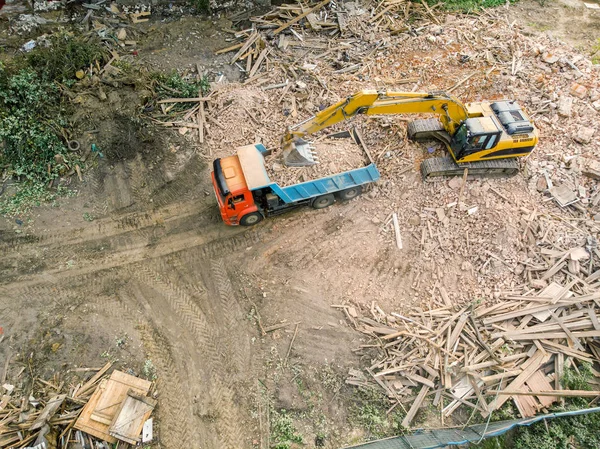 aerial view of demolition site. excavator clearing out urban redevelopment area