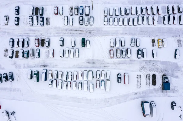 winter parking lot with cars covered with snow. view from above. aerial photo
