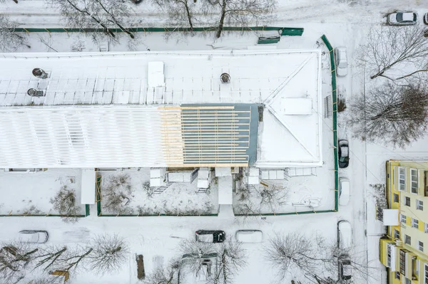 aerial top view of building roof under renovation in winter. residential area. drone photography