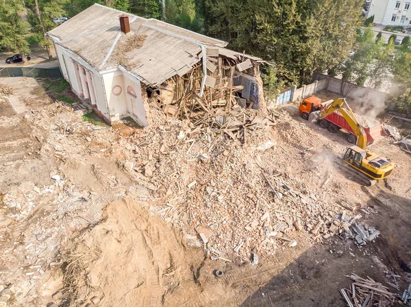 demolishing of old building. heavy construction machines clearing out construction site