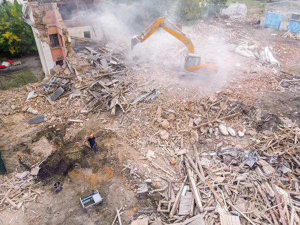 top view of demolition site with industrial machinery and workers clearing out the territory