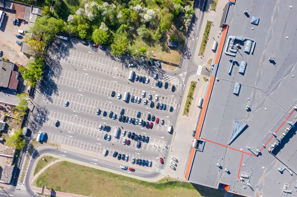 parking lot, aerial top view. a lot of cars parked near shopping mall