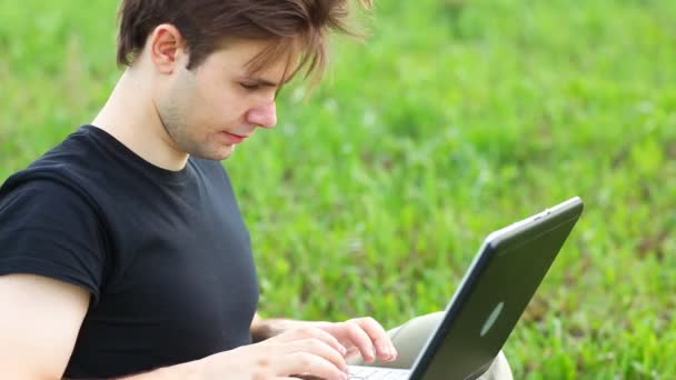 Young Man Summer Field Typing Laptop — Stock Video