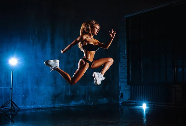 Young Fitness Woman Jumping High Dark Interior Blue Lights — Stock Photo, Image