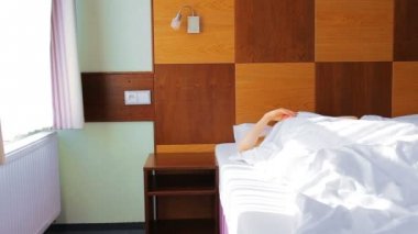 Genç kadın uyan yatakta güneşli sabah