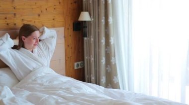 Yatakta yatarken ve pencereye gelecek genç kadın