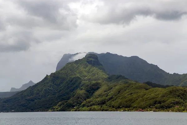 Huahine island overgrown with rainforest in Pacific ocean in the Leeward group of the Society Islands of French Polynesia.