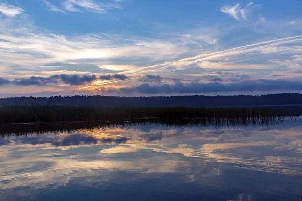 Beautiful sunrise  - as the morning sun lights the clouds and reflects on the surface of the Gauja river, Latvia.