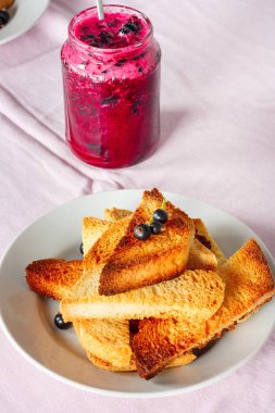 Ev yapımı frenk üzümü lezzetli Tost ekmeğine reçel parlak koyu kırmızı masa örtüsü üzerinde