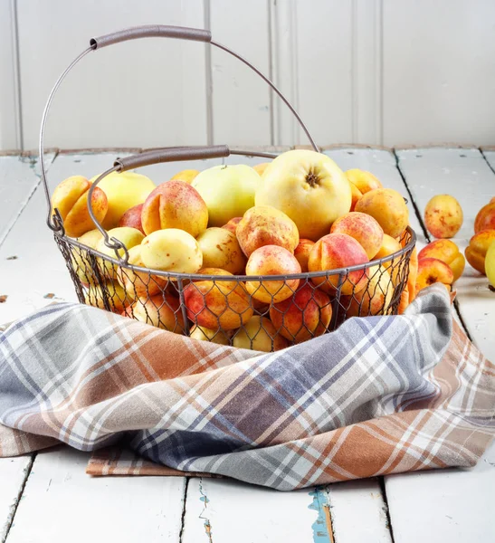 Ripe Tasty Fresh Apricots Apples Woven Metal Basket Wooden Table — Stock Photo, Image