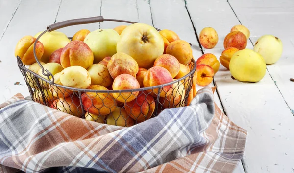 Ripe Tasty Fresh Apricots Apples Woven Metal Basket Wooden Table — Stock Photo, Image