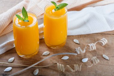 Tohum ve nane ile sağlıklı kabak meyve güler yüzlü eski ahşap masada bırakır.