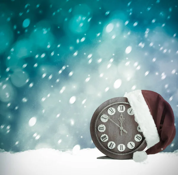 サンタ クロースの帽子と時計 クリスマスの雪の夜 — ストック写真