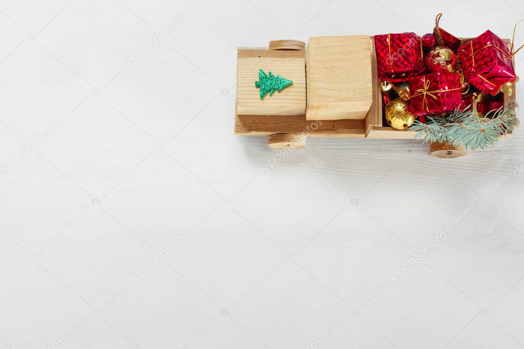 Old vintage toy wooden car with gifts and Christmas balls on white background. Top View Flat Lay Group Objects