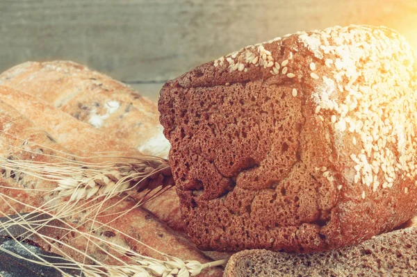 Bread from rye and wheat flour of rough grinding in wicker basket on wooden table