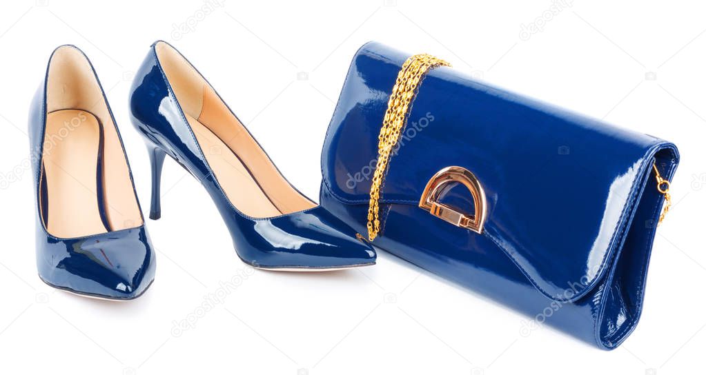 Beautiful  blue shoes with clutches on white isolated background