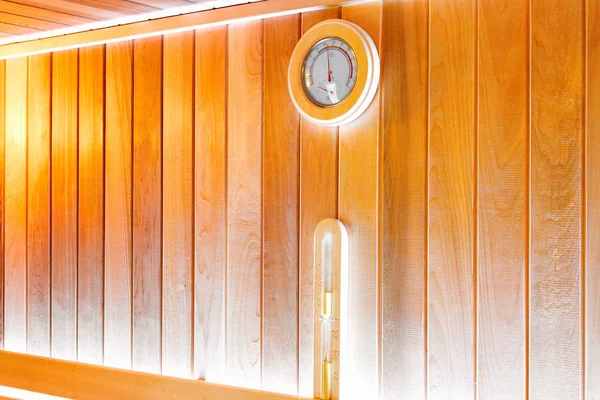 Round thermometer and hourglass on the wall of traditional wooden sauna — Stock Image Thermometer Hourglass Wall Traditional Wooden Sauna Royalty Free Stock Images