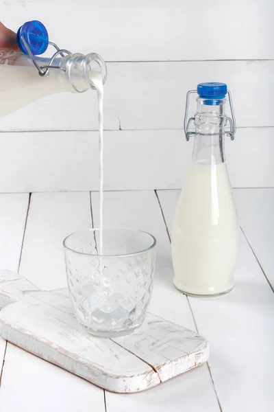 Old  vintage style bottles with fresh milk on  white wooden table — Stock Photo, Image