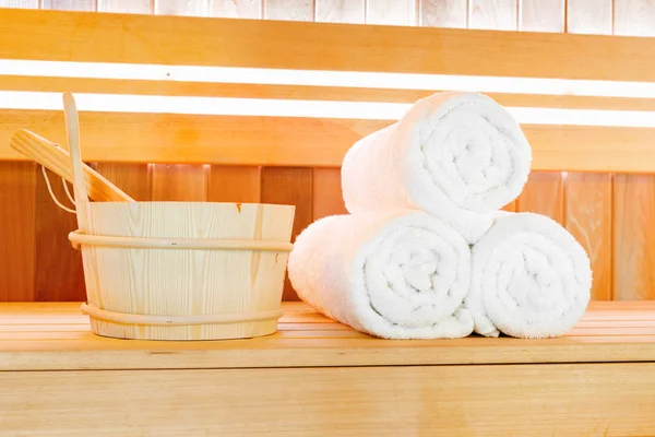 Traditional wooden sauna for relaxation with set of clean towels — Stock Photo, Image