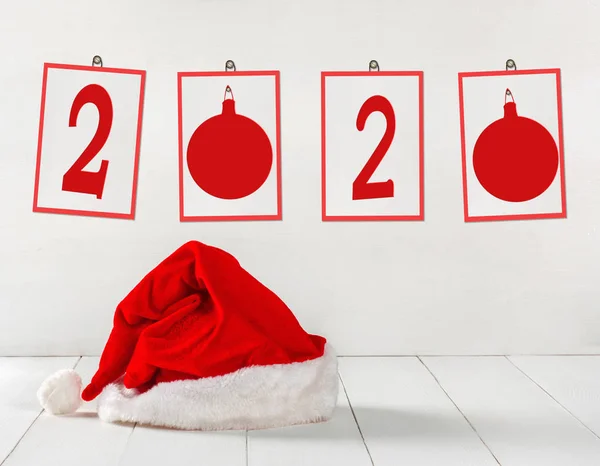 Bright red Santa Claus hat with paper frames and number 2020 — Stock Photo, Image