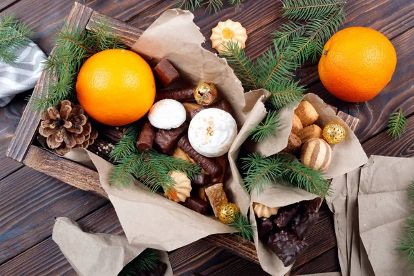 Delicious sweets, chocolates, cookies and oranges for gifts in — Stock Photo, Image