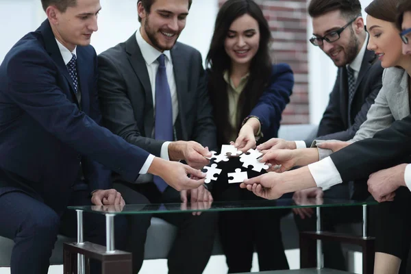 Geschäftsteam löst gemeinsam Puzzle. — Stockfoto