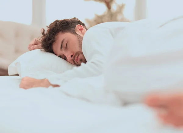 Closeup.the tired men sleep soundly on the bed — Stock Photo, Image