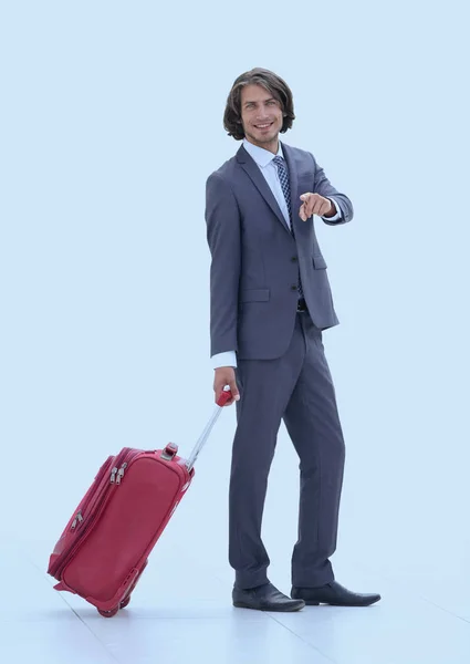 Businessman with travel suitcase pointing forward — Stock Photo, Image