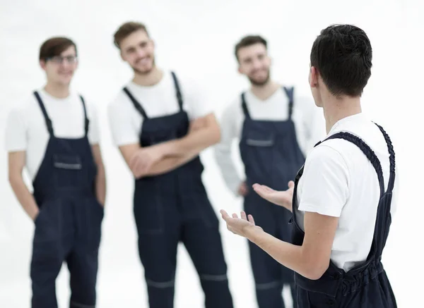 Cheerful team of responsible movers and their smiling leader. — Stock Photo, Image