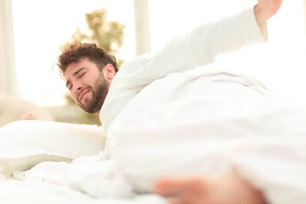 Close seup.tired men asleep on the bed — стоковое фото