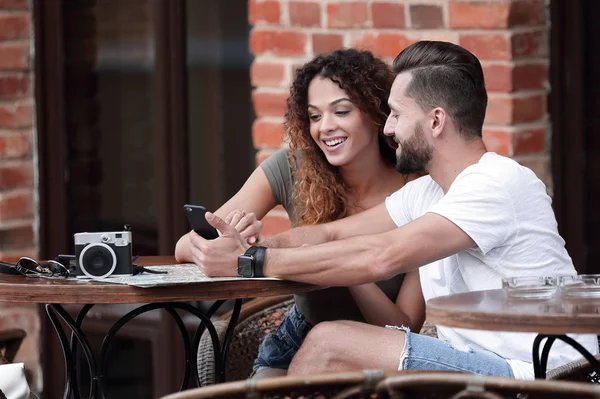 Porträtt av ett ungt par som sitter vid ett kafé-terrass — Stockfoto