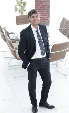 Bir boş toplantı odasında duran iş adamı