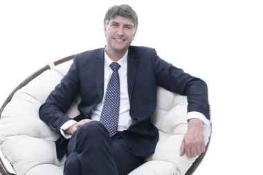 Başarılı bir iş adamı yumuşak bir rahat sandalyede oturur.